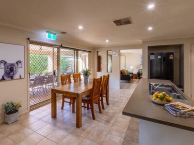 Kitchen and dining area. With a nice benchtop and dining table nearby.
