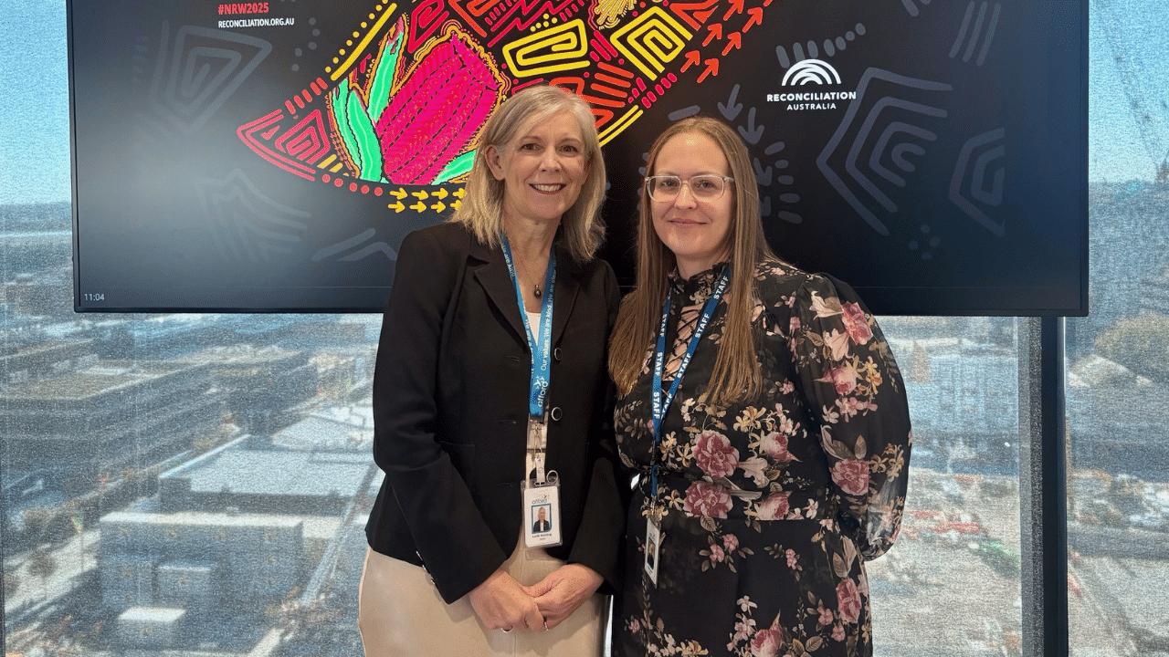 RAP Working Group co-chairs Kym Mafi (R) with Afford COO Leith Sterling honouring National Reconciliation Week.